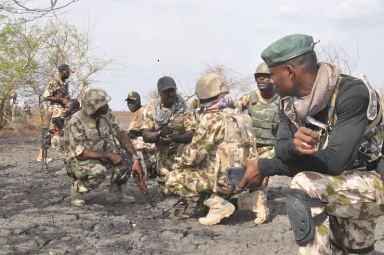 Nigerian troops strategising before attacking a Boko Haram hideout
